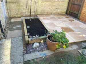 Patio with Concrete Riven Slabs and Vegetable Patch in Carterton, Oxfordshire