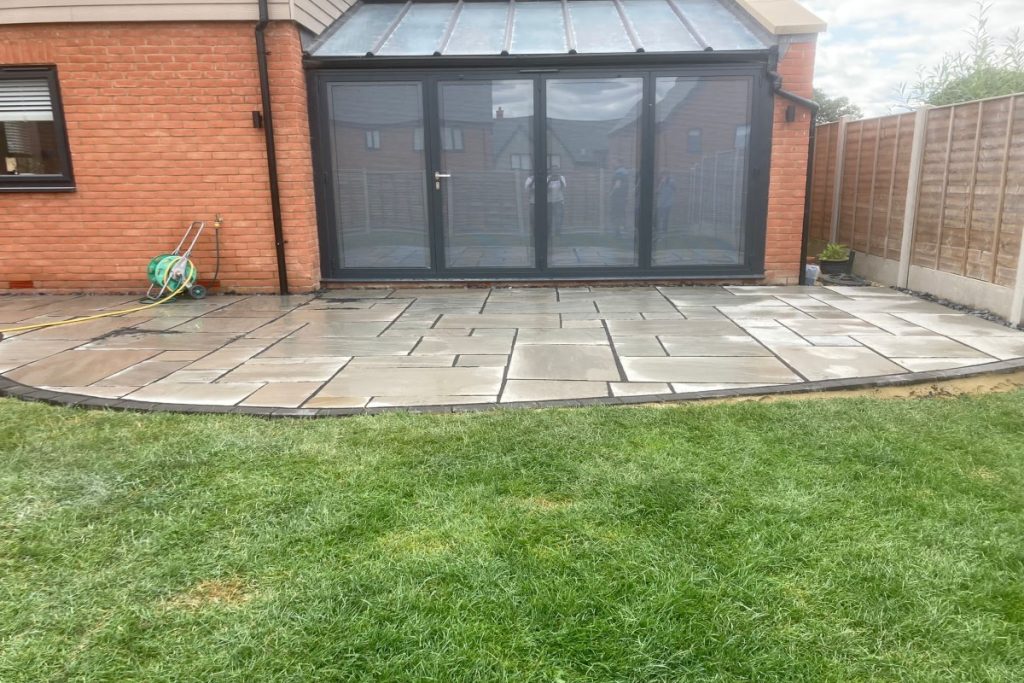 Grey Sandstone Slabbed Patio with Black Grout and French Gravel Drains in Hamstead (6)